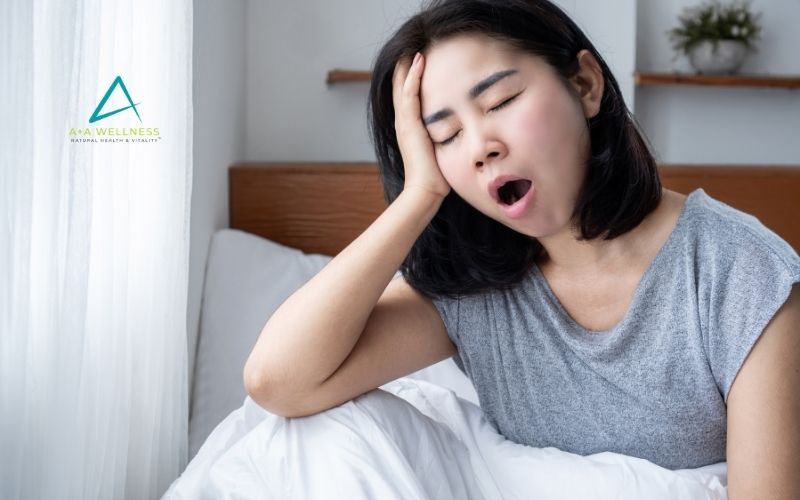 Woman reviewing her wellness routine while experiencing stress, fatigue, poor sleep and digestive concerns.